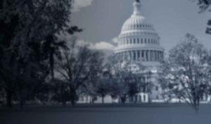 U.S. Capitol building with surrounding trees.
