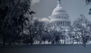U.S. Capitol building behind trees, monochrome image.