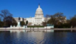 Blurry image of a domed building and water.