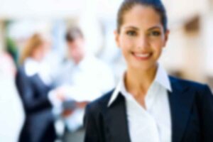 Smiling professional woman in business attire.