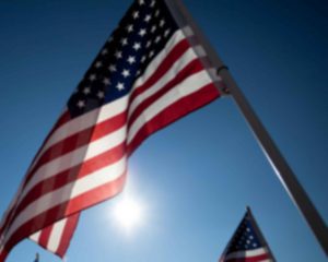 American flags waving under a clear sky.