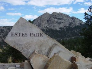 Rocky mountain landscape with Estes Park sign.